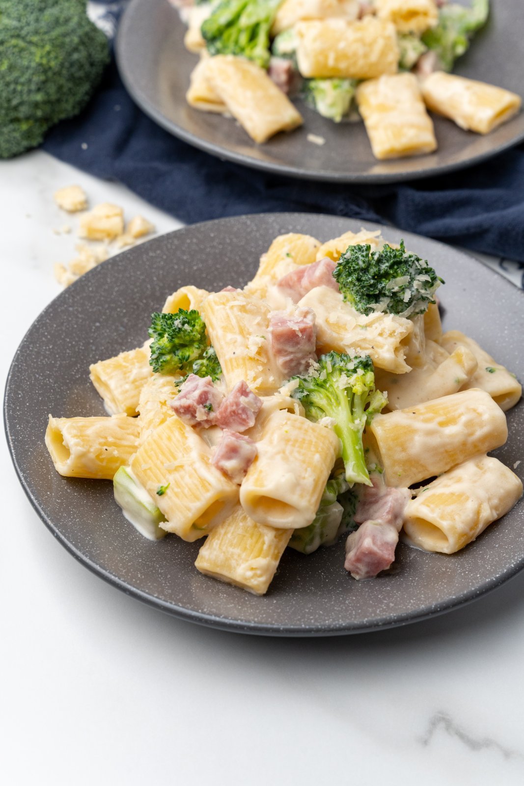 a plate of ham broccoli alfredo