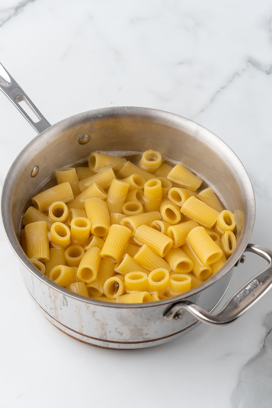 a pot with half cooked noodles