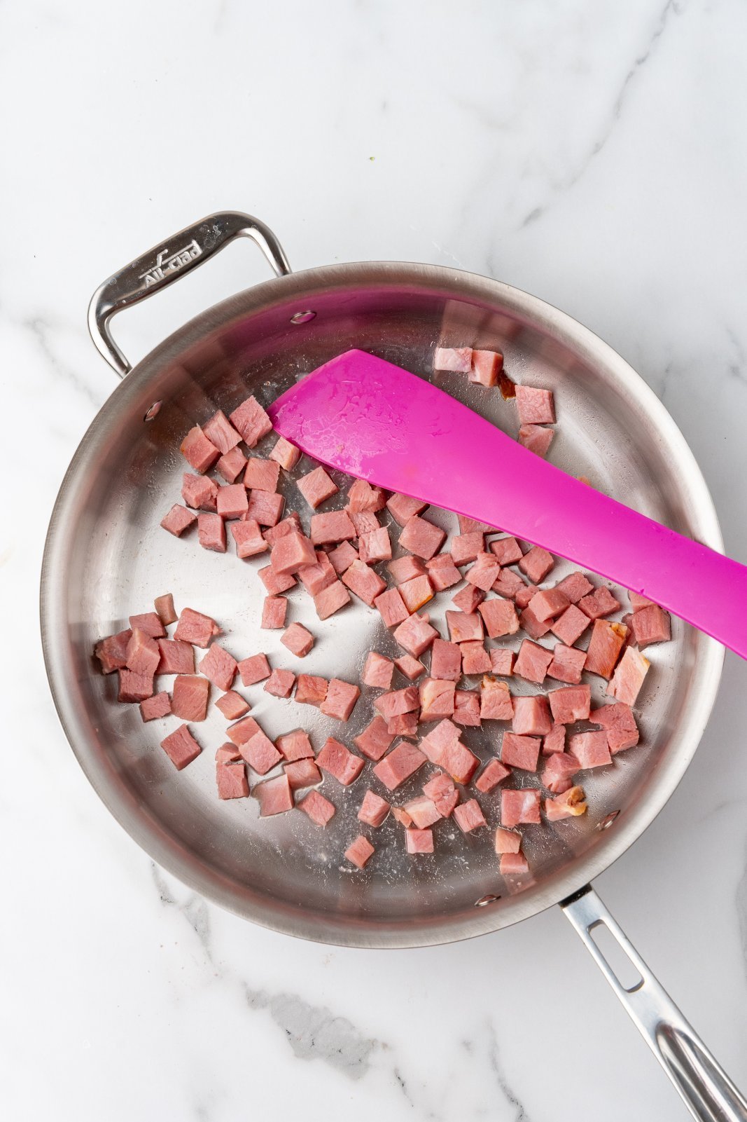 a large skillet with ham