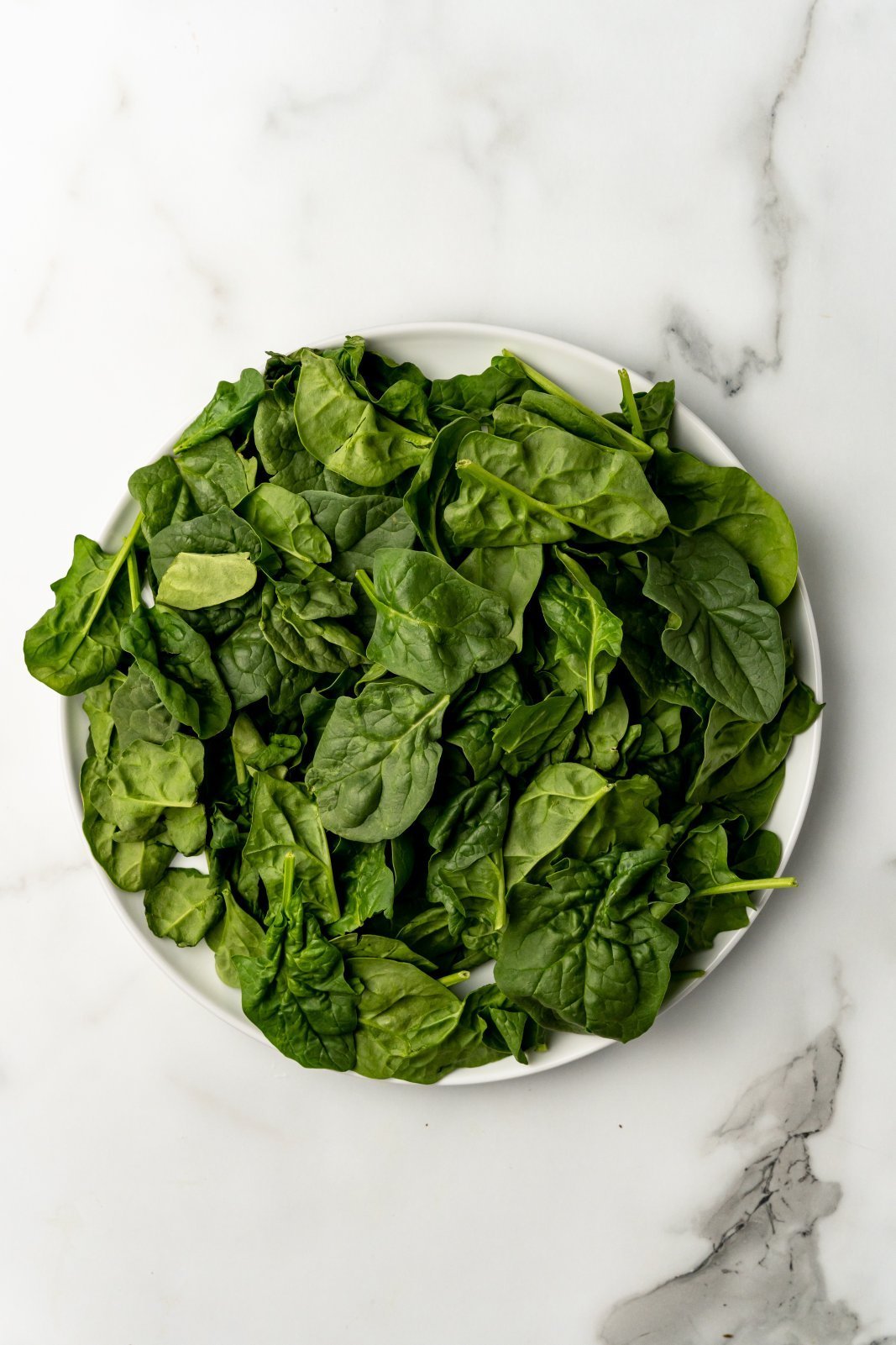 a large plate with spinach