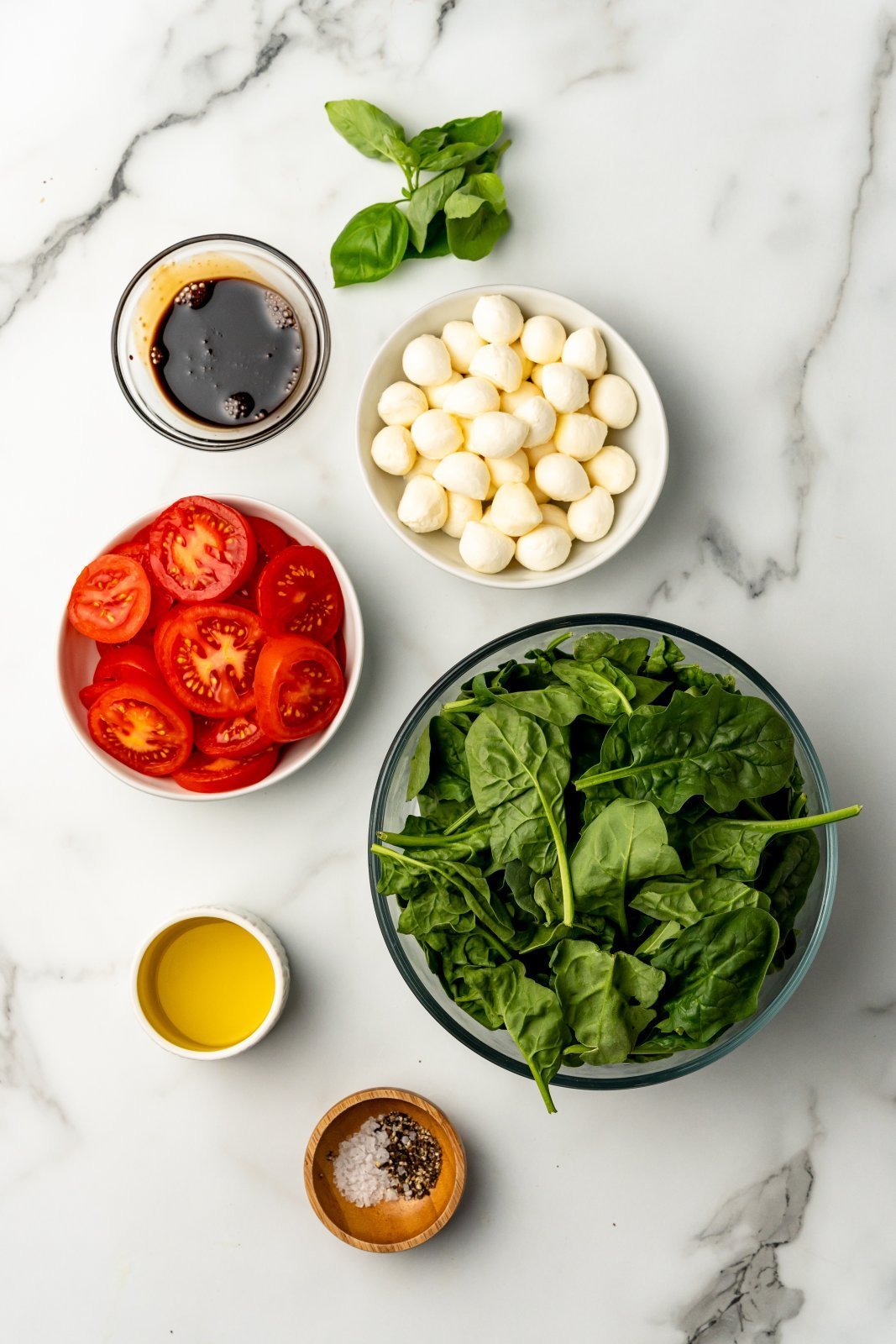 top down view of ingredients needed for caprese spinach salad