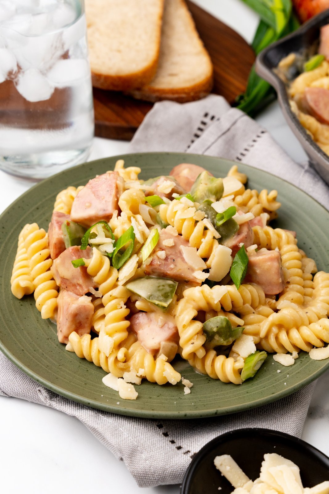 Kielbasa cheesy pasta on a green plate