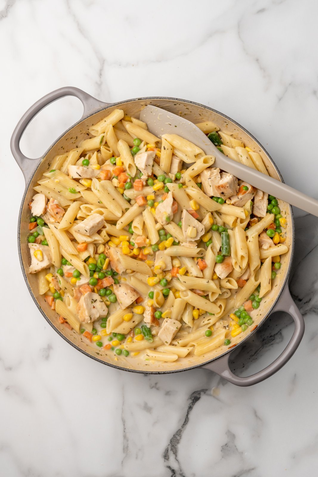 penne and chicken mixed into the sauce with veggies