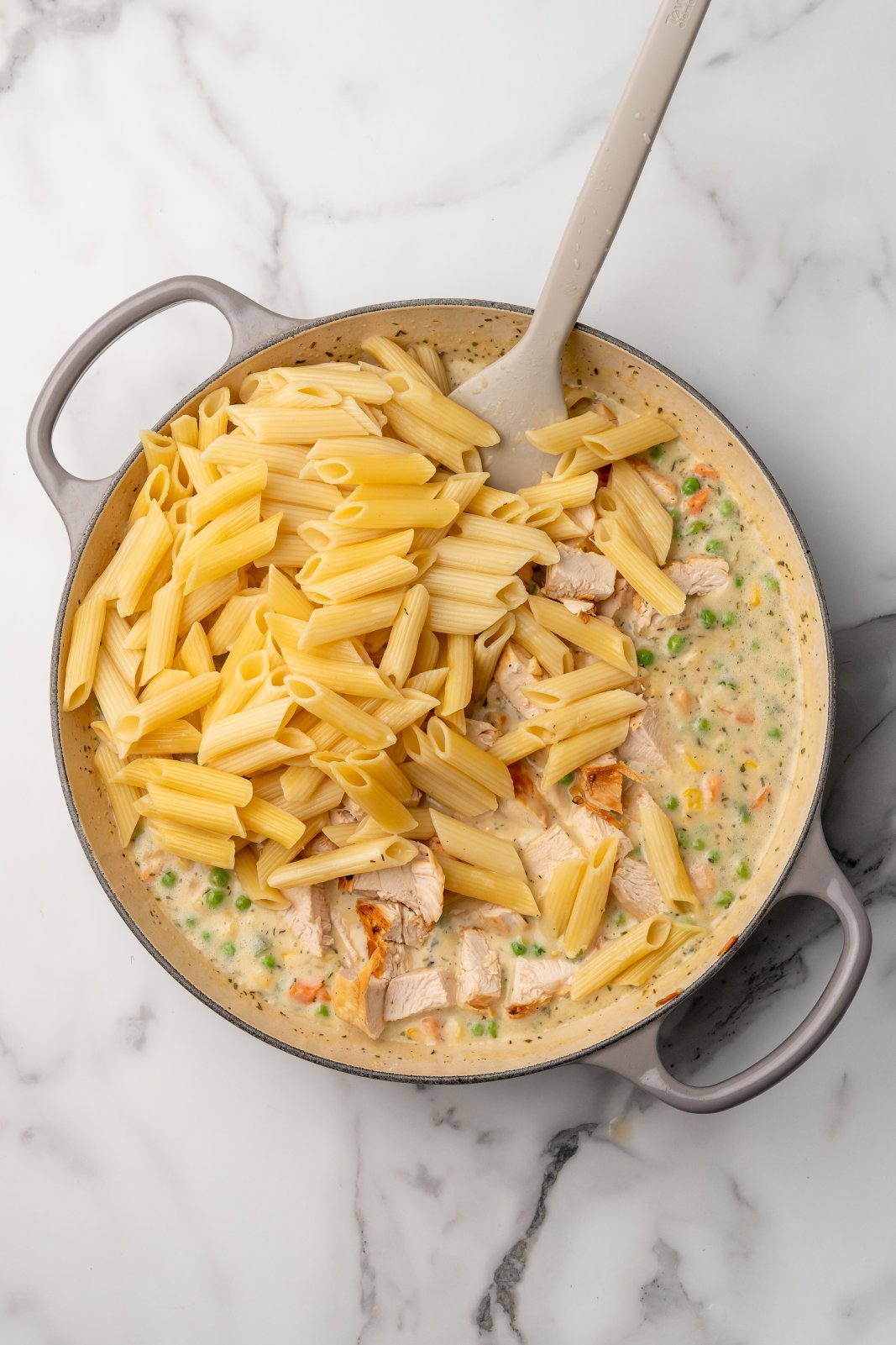 penne and chicken added to the pot