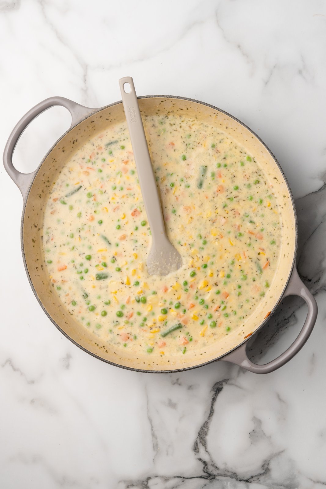 veggies in a pot covered with a thickened sauce