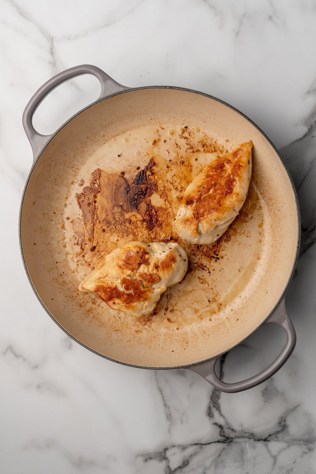 fully cooked chicken breasts in a large pan