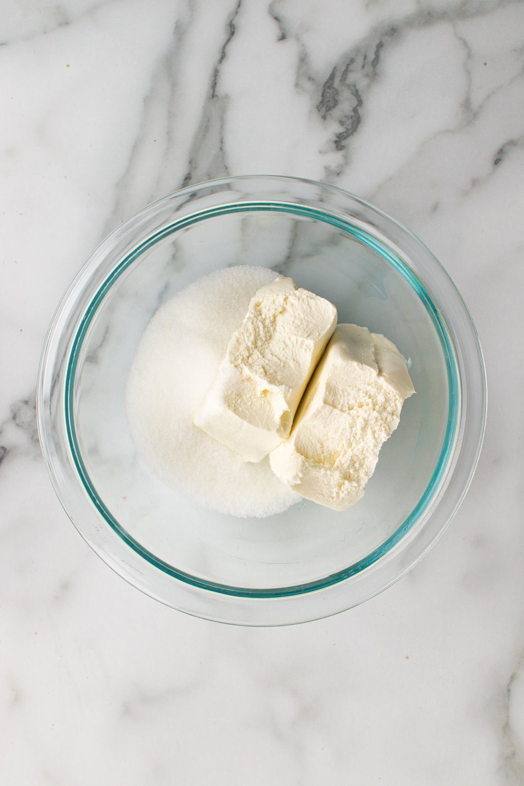a bowl with cream cheese and sugar