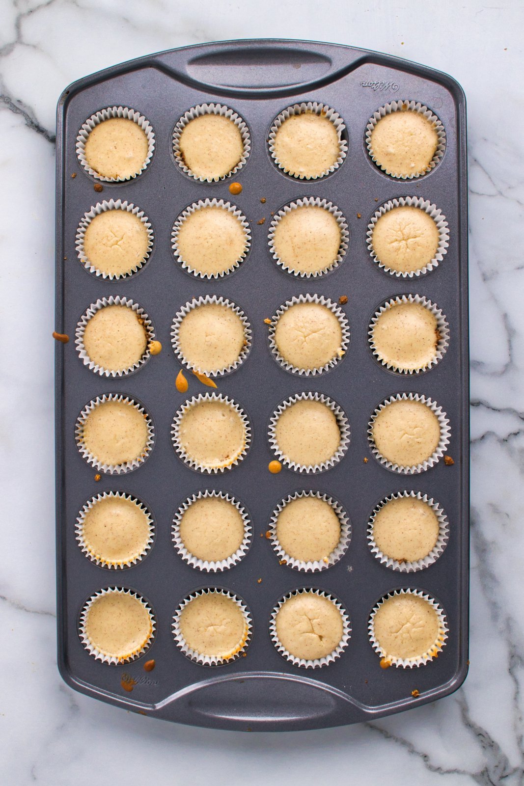 a tray of cooked cheesecake bites