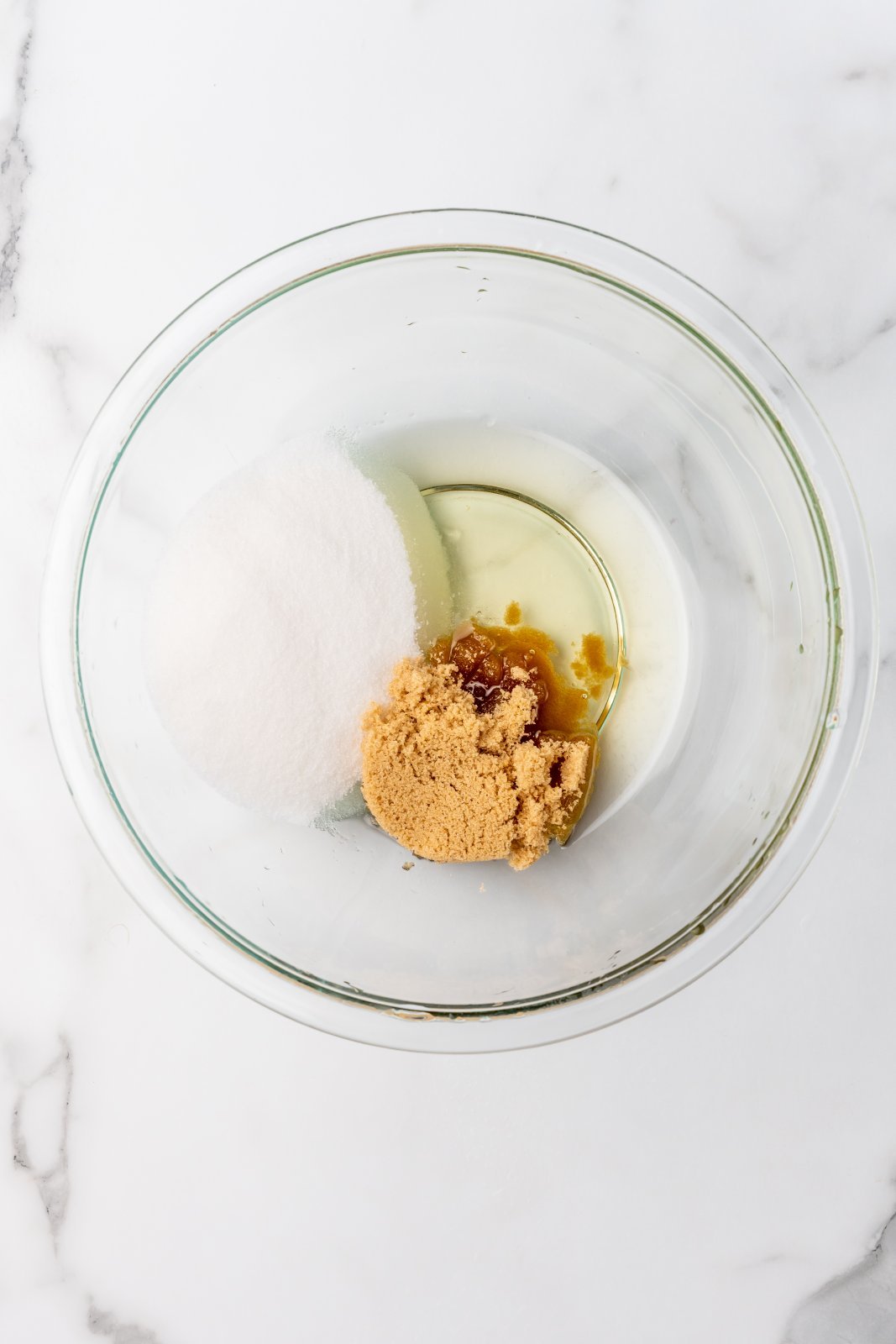 oil and sugars in a large bowl