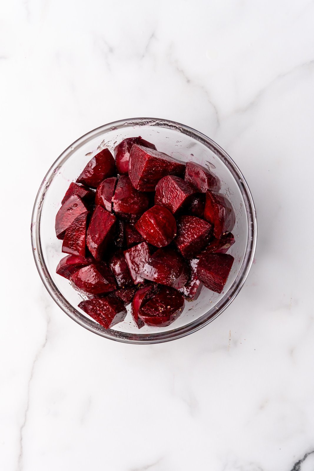 beets in a bowl tossed with seasoning