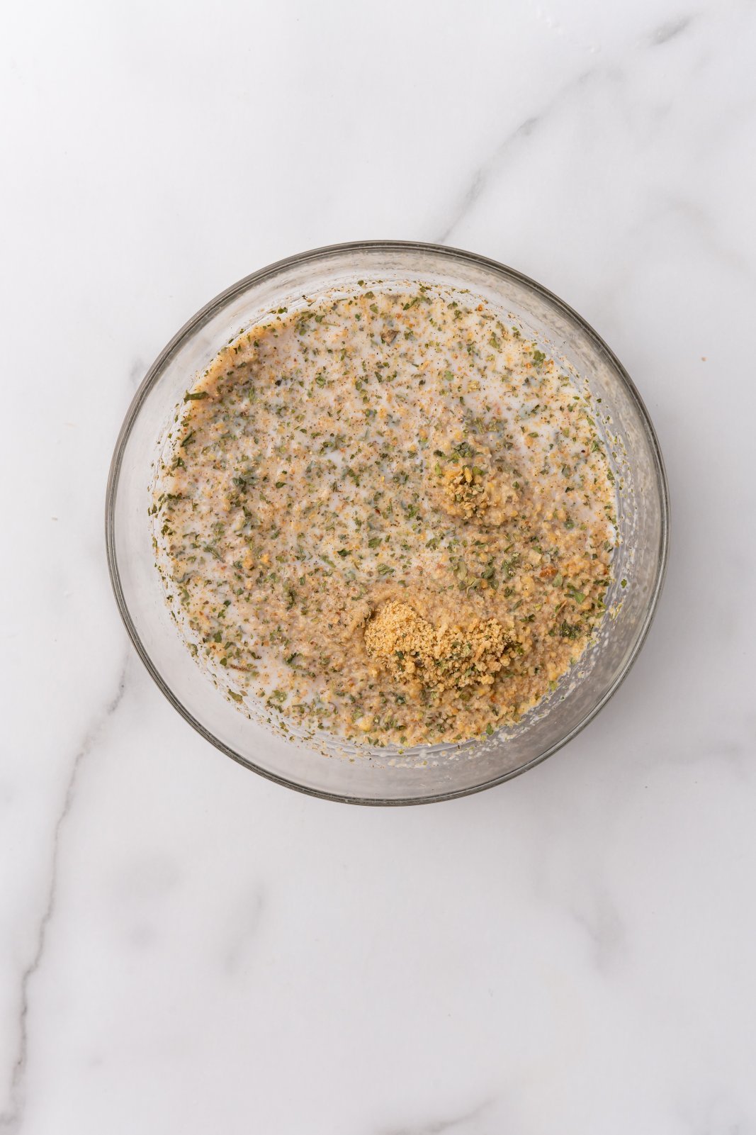 milk on top of breadcrumbs in a small bowl