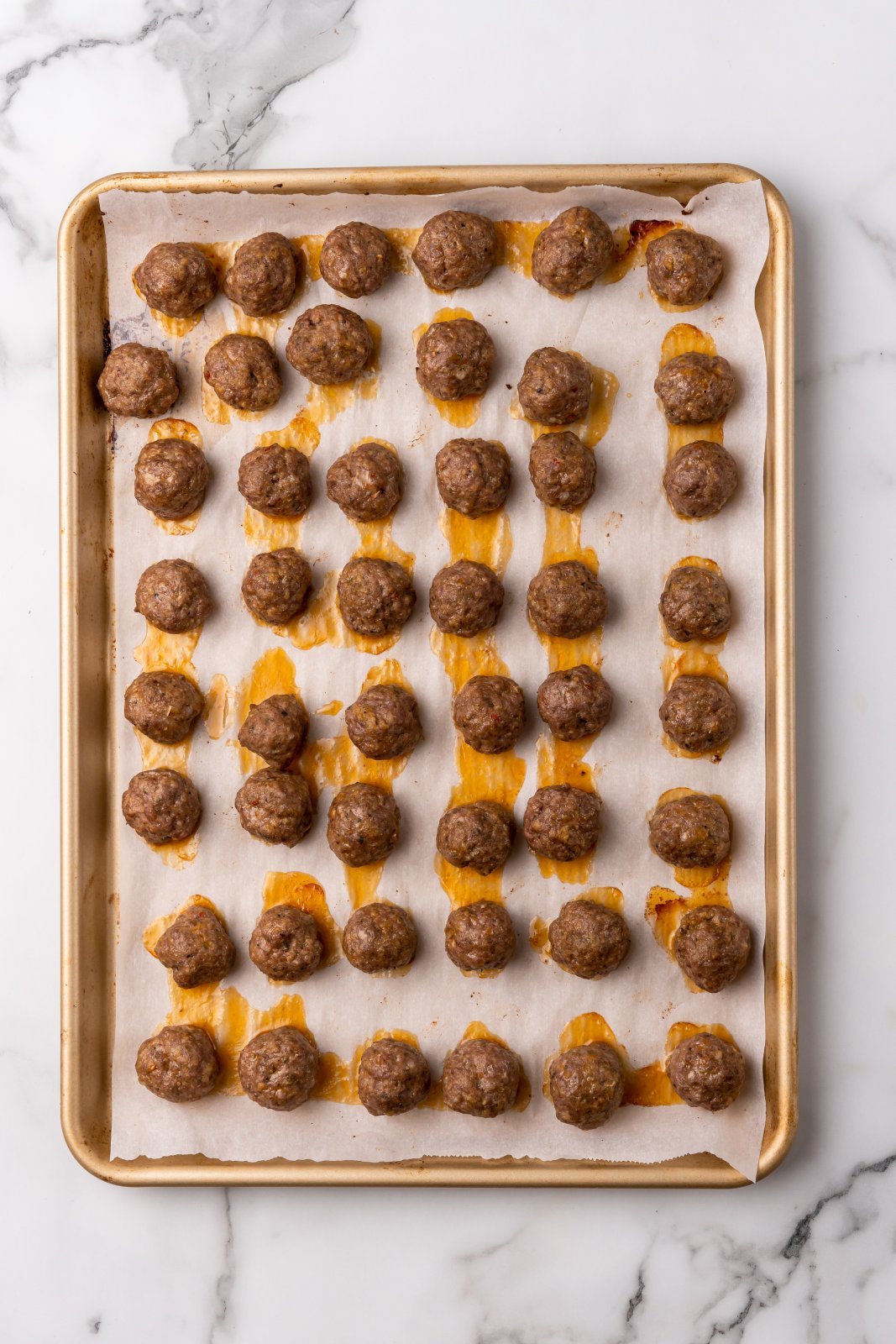 cooked meatballs on a sheet pan