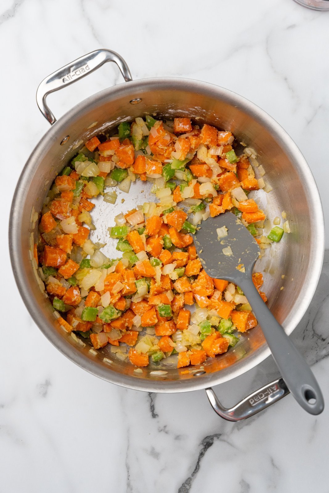 flour mixed into onion, carrot, and celery in a large stockpot