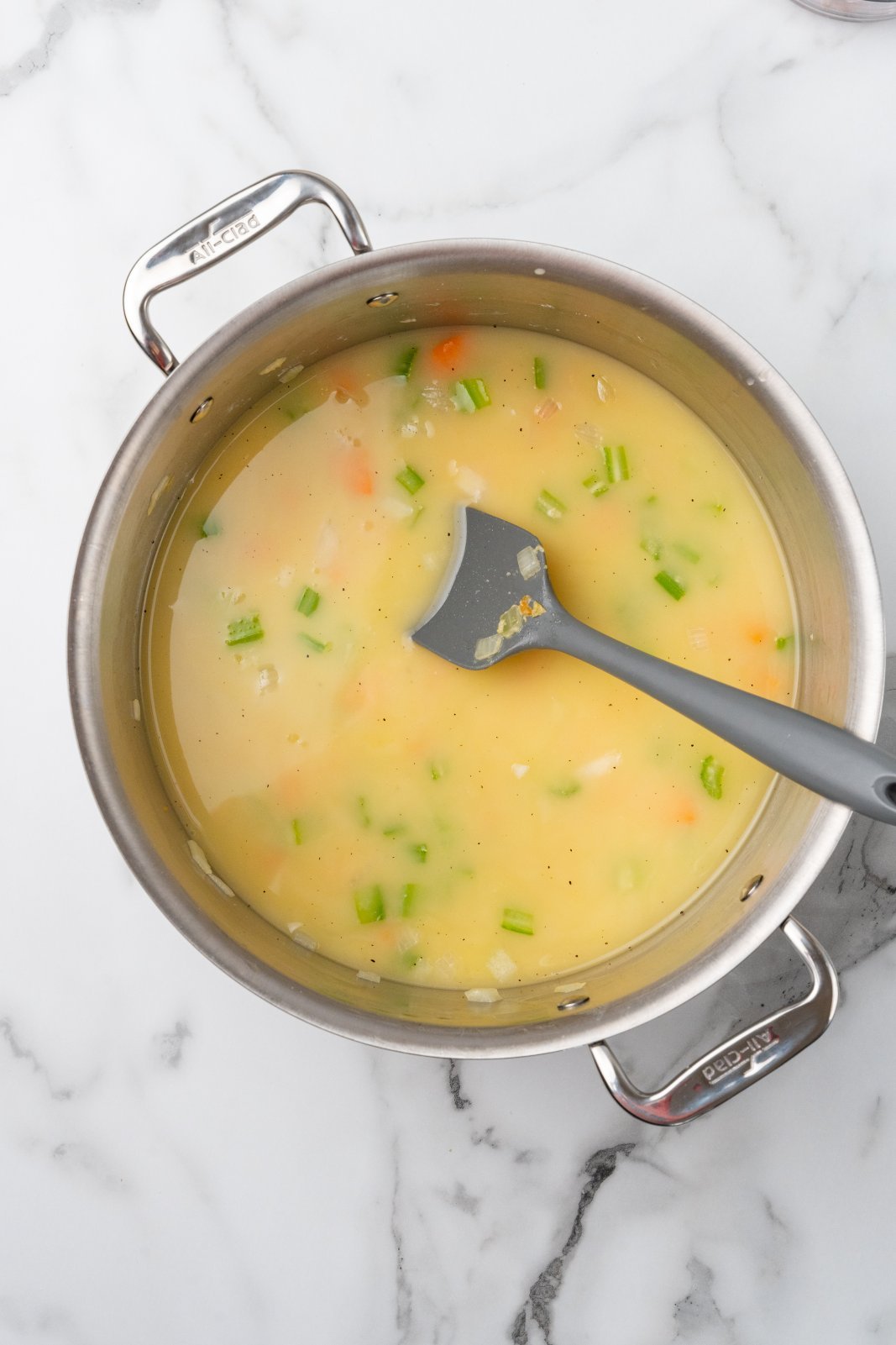 broth added to onion, carrot, and celery in a large stockpot