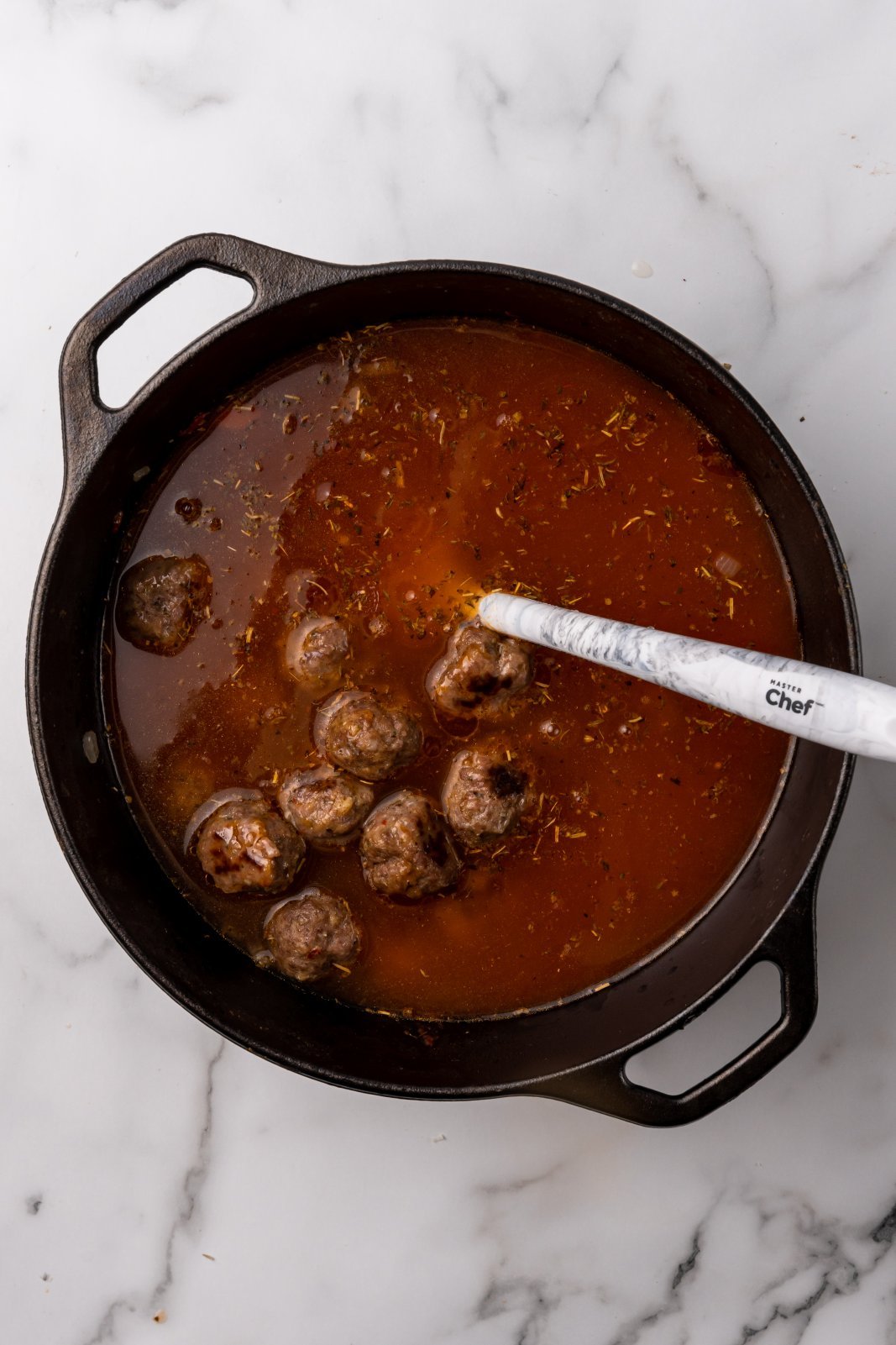 a view of the soup pot with meatballs and broth added