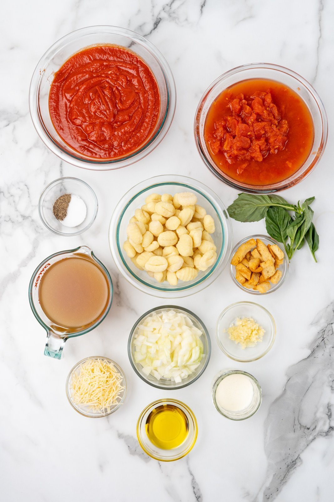 a top down view of all the ingredients required for creamy tomato gnocchi soup