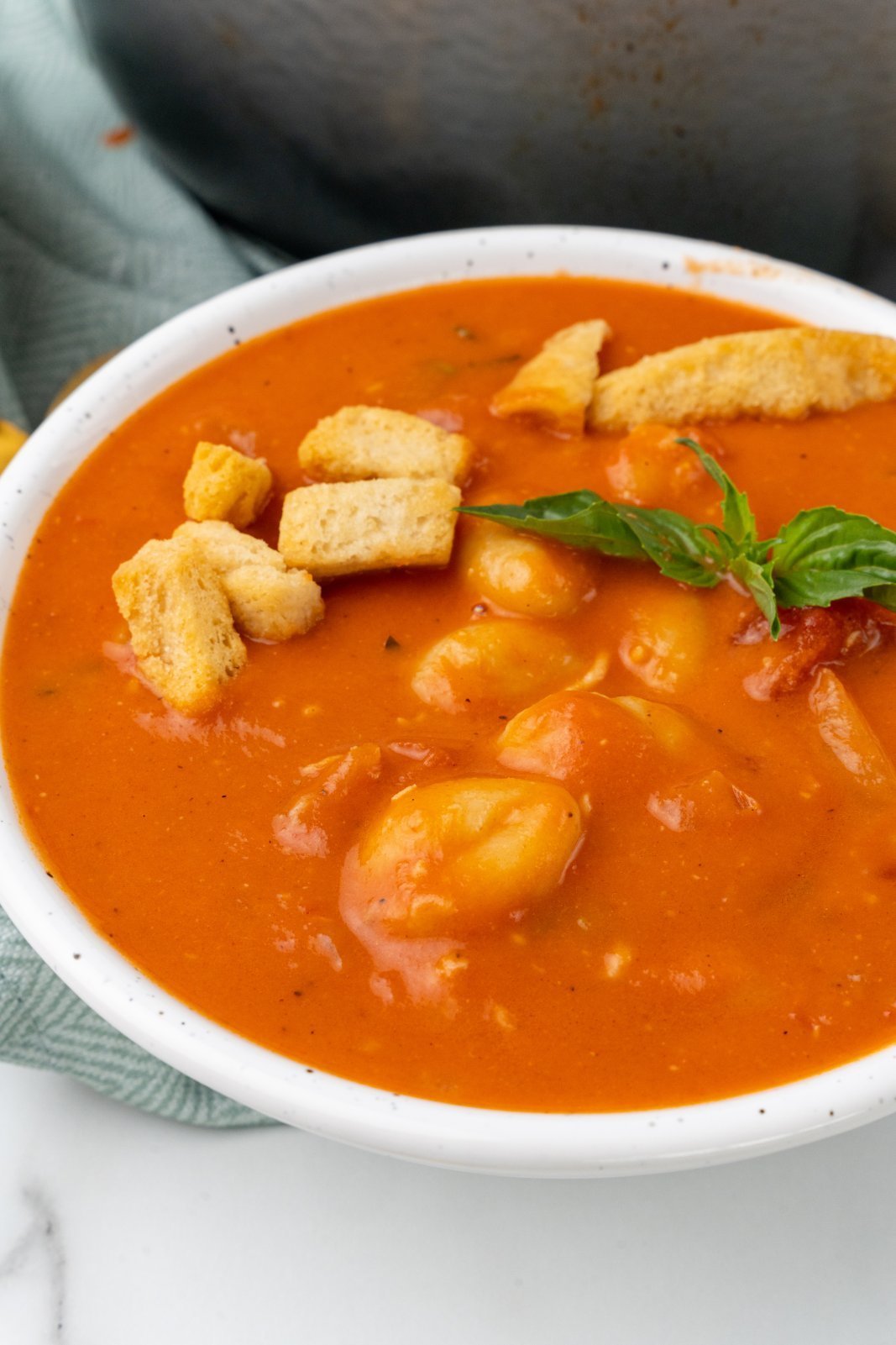 a close up of tomato gnocchi soup