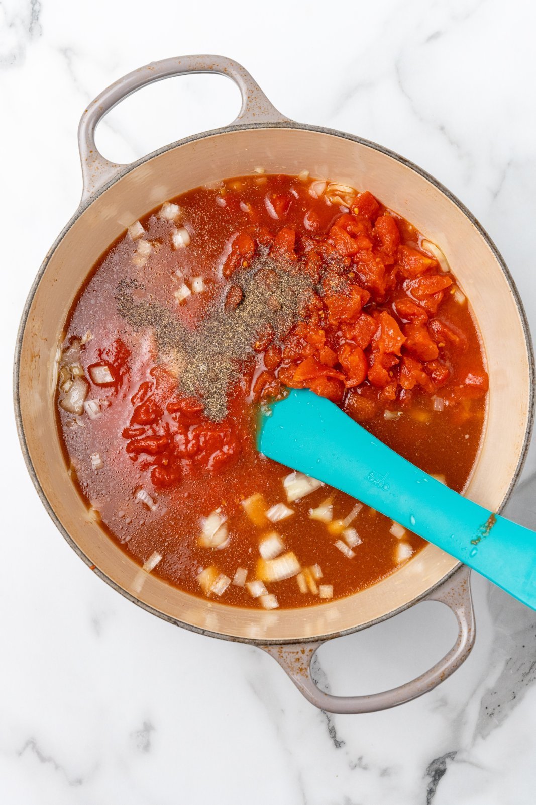 the soup before simmering in the bottom of a large grey dutch oven