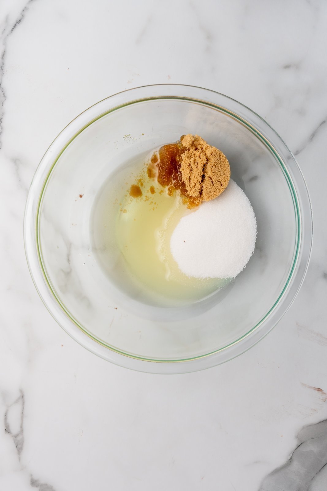 oil and sugars in a large bowl