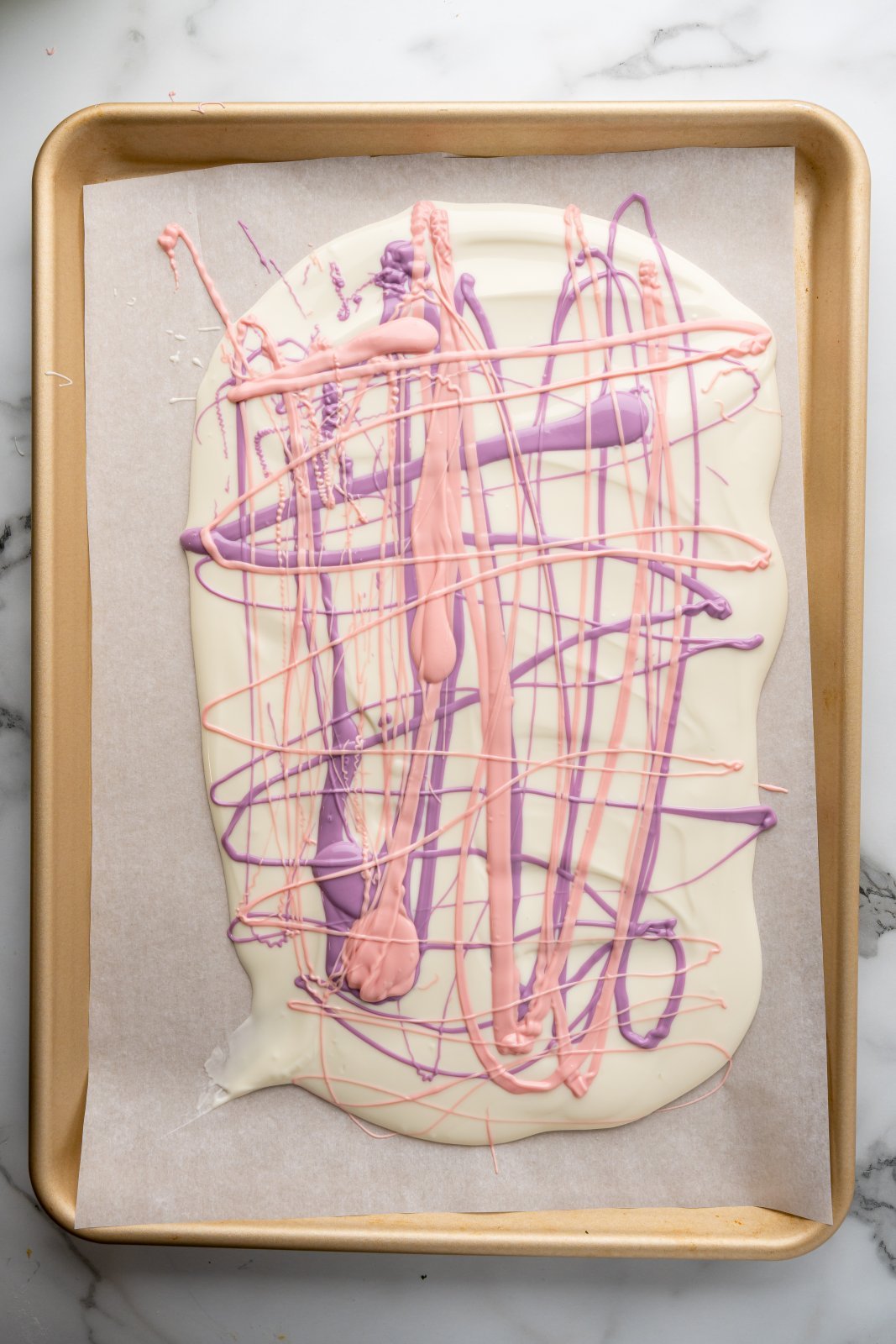 white chocolate with purple and pink chocolate drizzled over