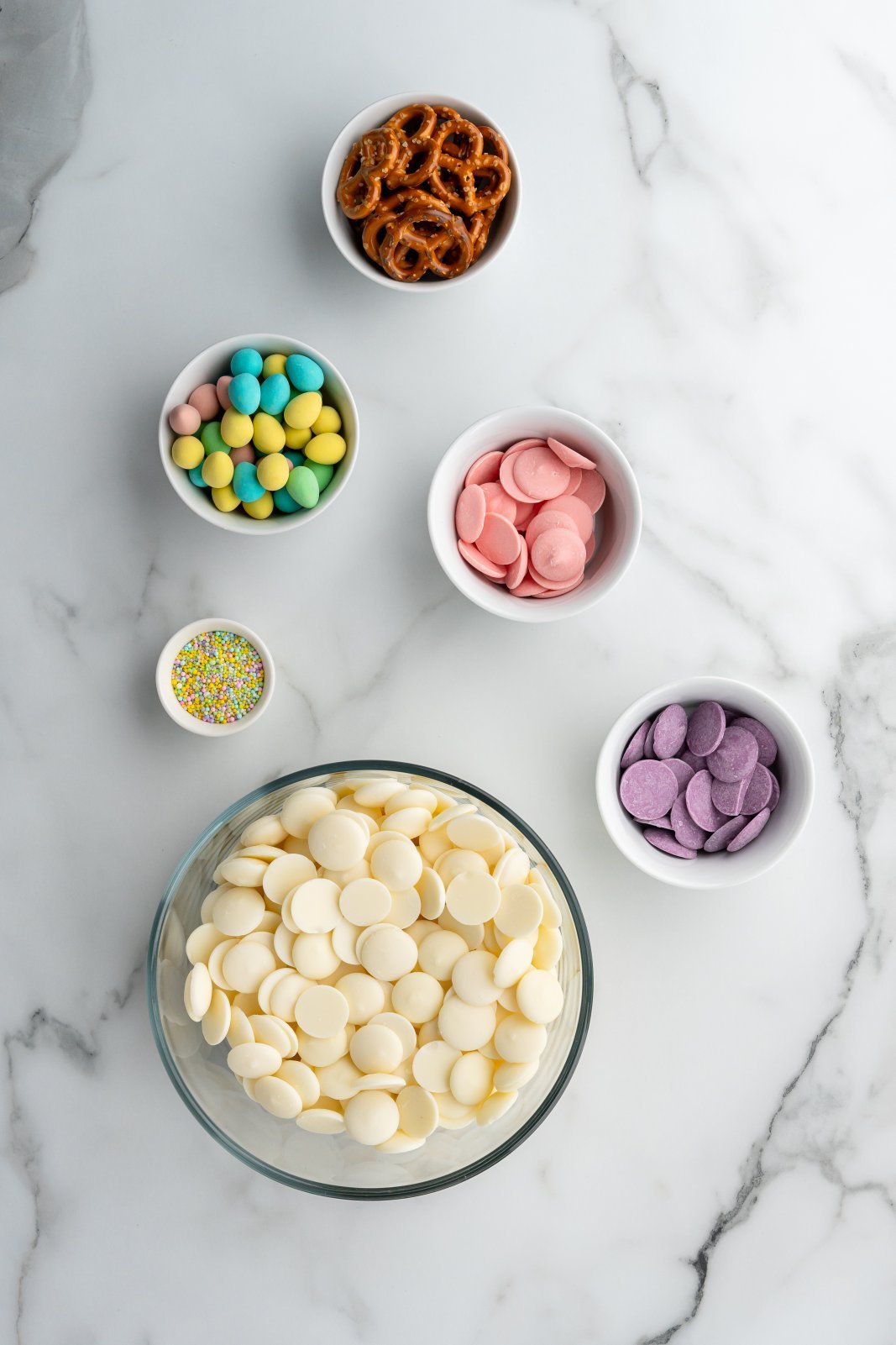 a top down shot of ingredients needed for easter egg pretzel bark
