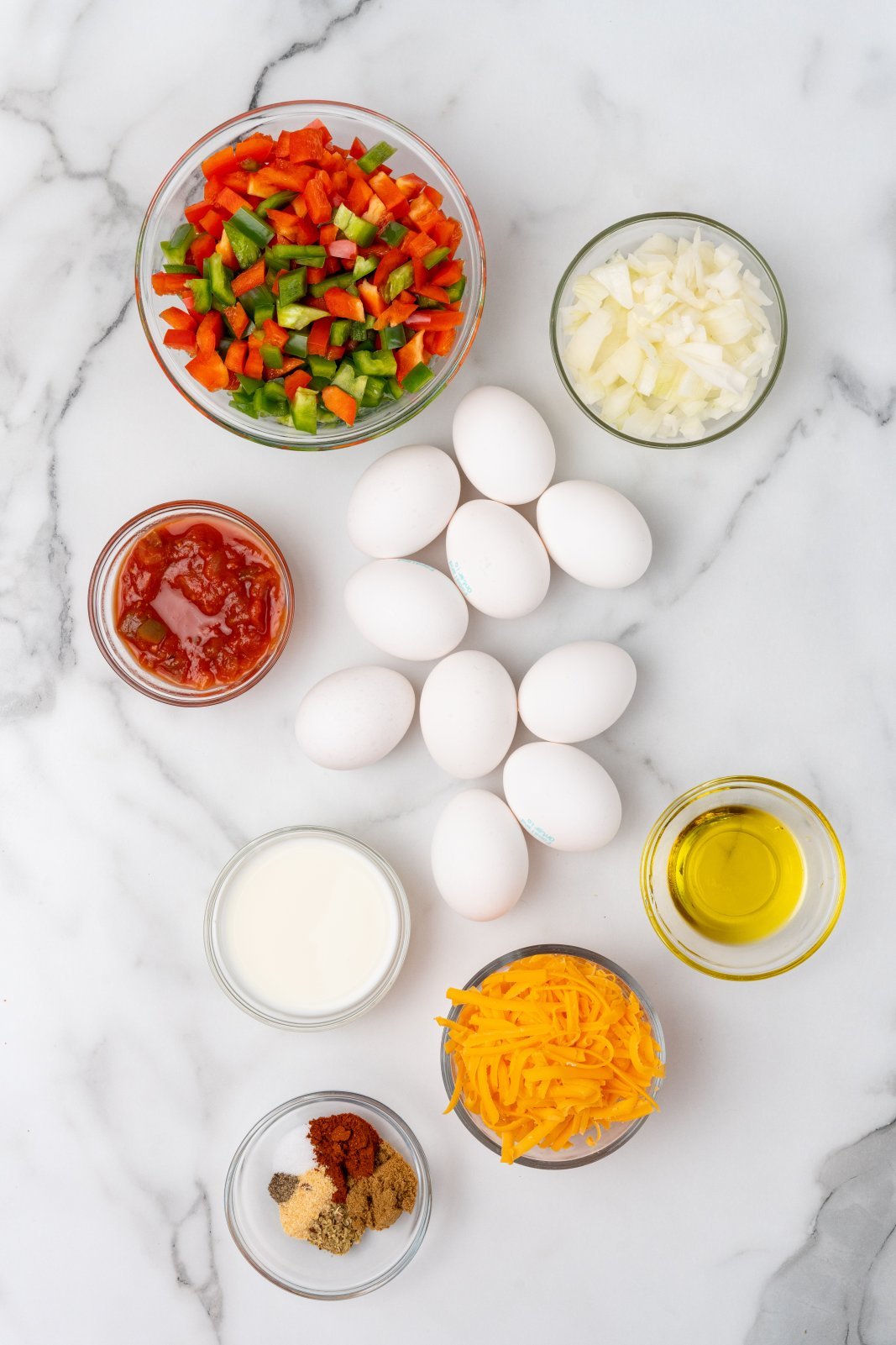 all the ingredients needed for fajita egg bites shown on a marble counter