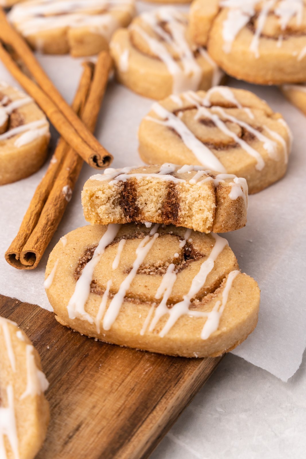 a cookie with a bite taken out is shown propped on top of other cookies