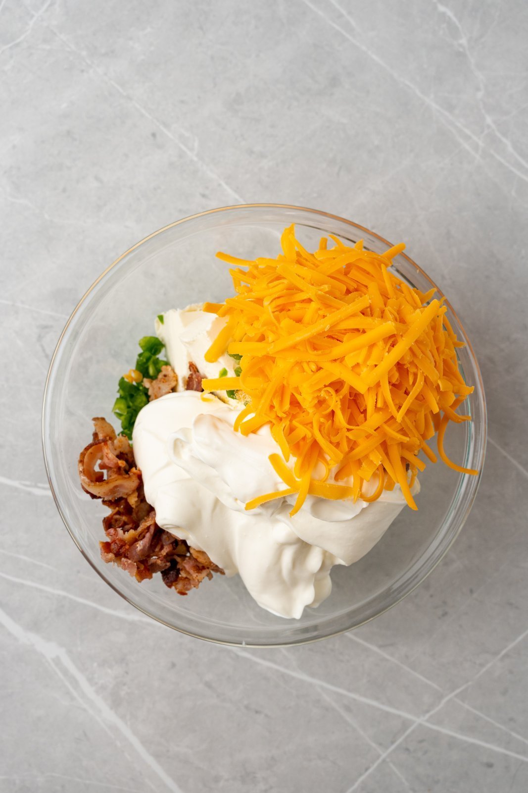 a bwol with the ingredients for jalapeno popper