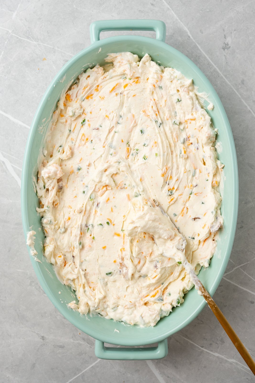 the dip smoothed into the bottom of a casserole dish