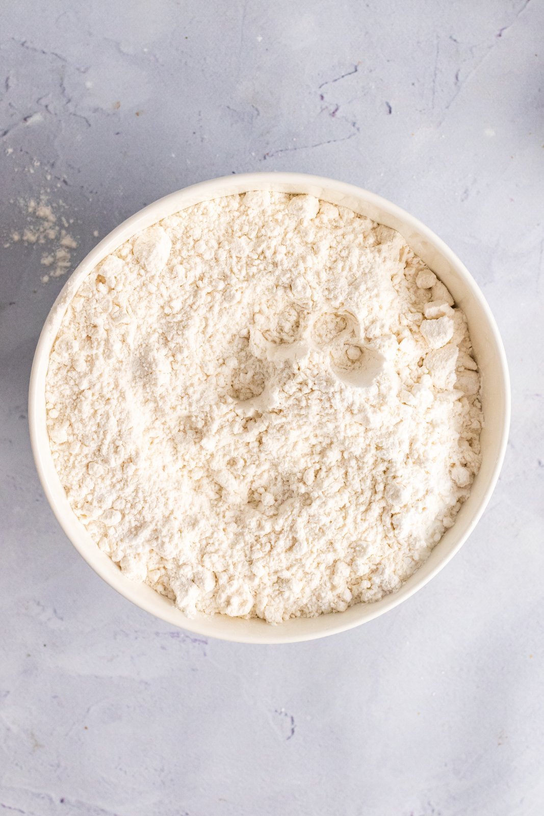 a bowl with flour, baking powder, and salt is shown