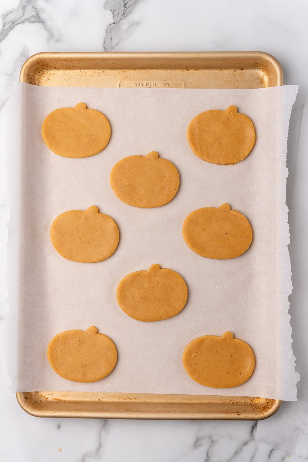 raw pumpkin cookies on baking sheet