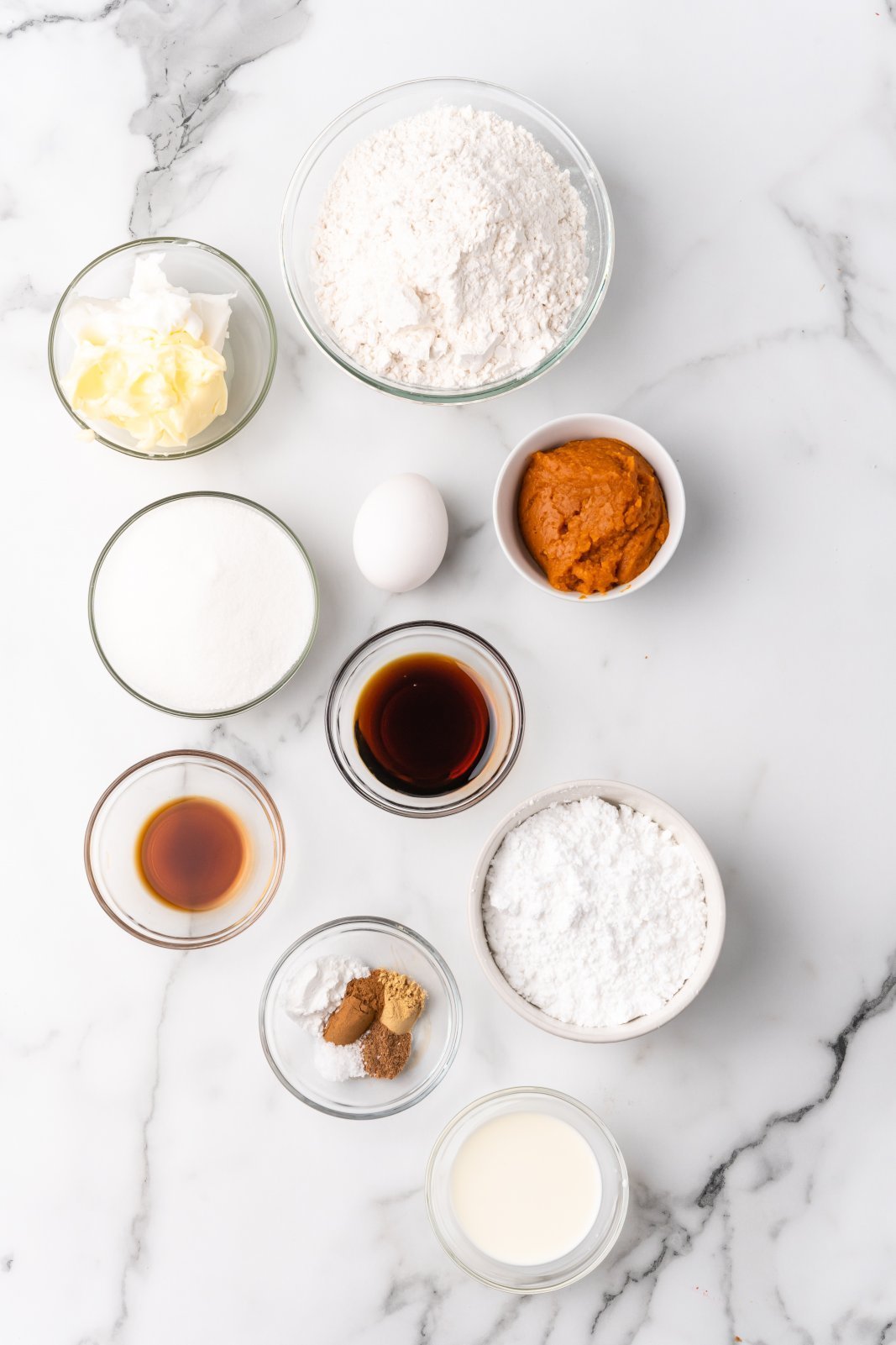 A top down view of the ingredients needed for pumpkin sugar cut-outs