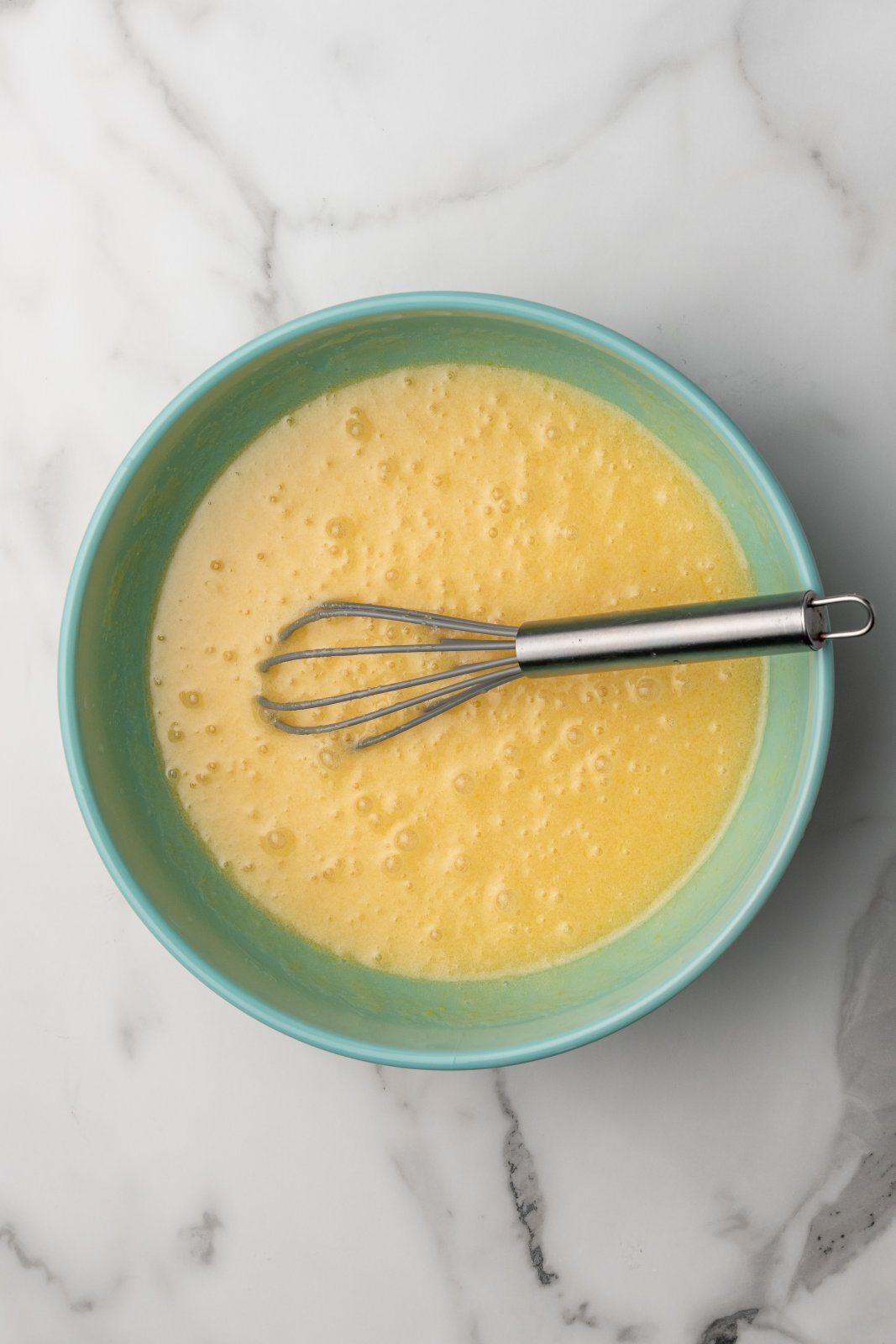 a mixture of sugar, egg, butter and vanilla in a bowl