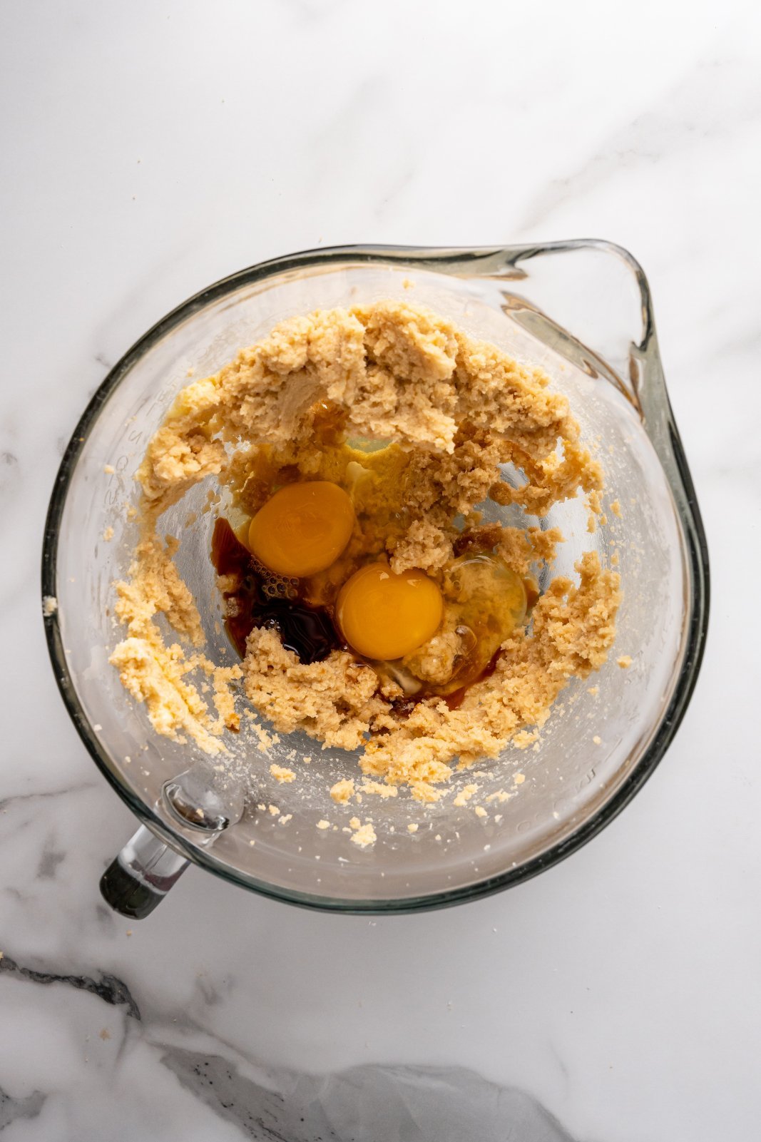 a bowl with eggs waiting to get mixed into the butter