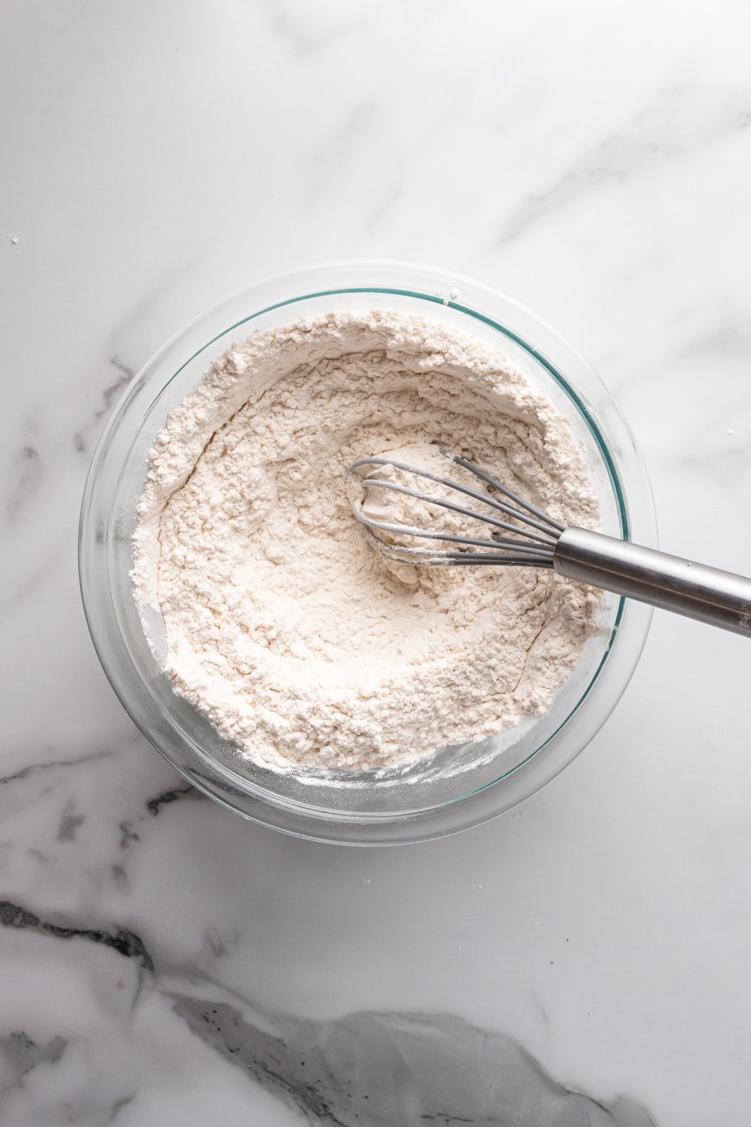 a bowl with flour mixture and a whisk
