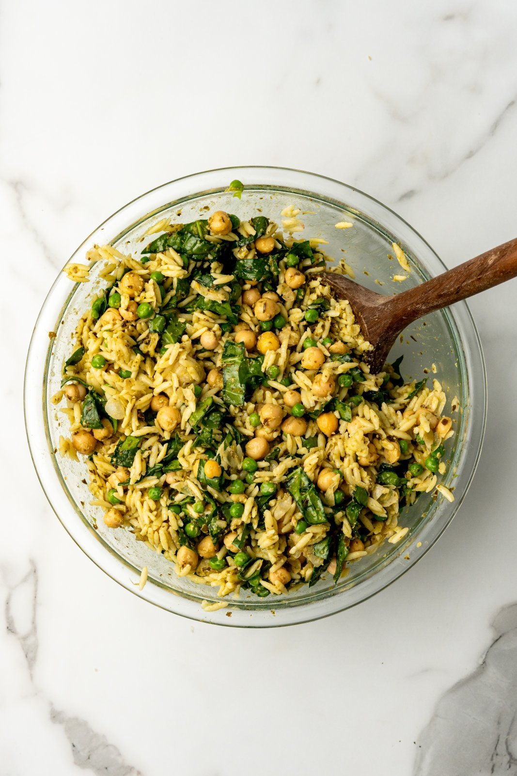ingredients for orzo pesto salad in a large bowl after mixing