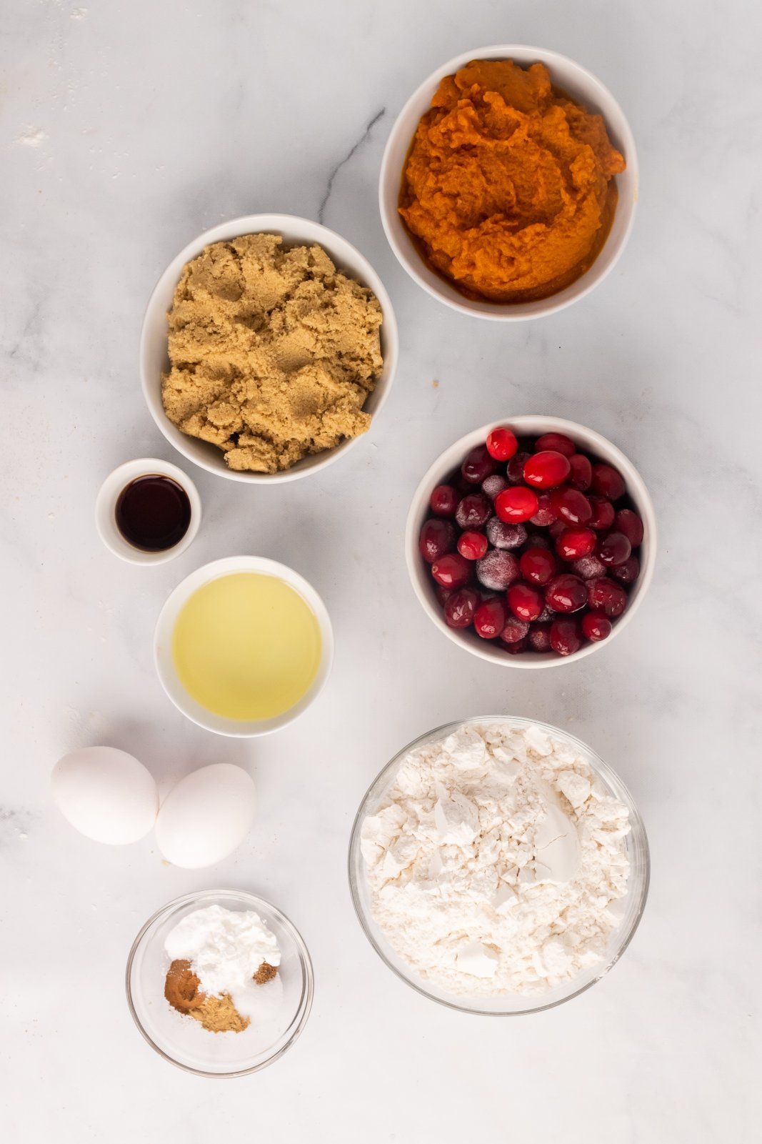 a view of all the ingredients needed to make pumpkin cranberry muffins