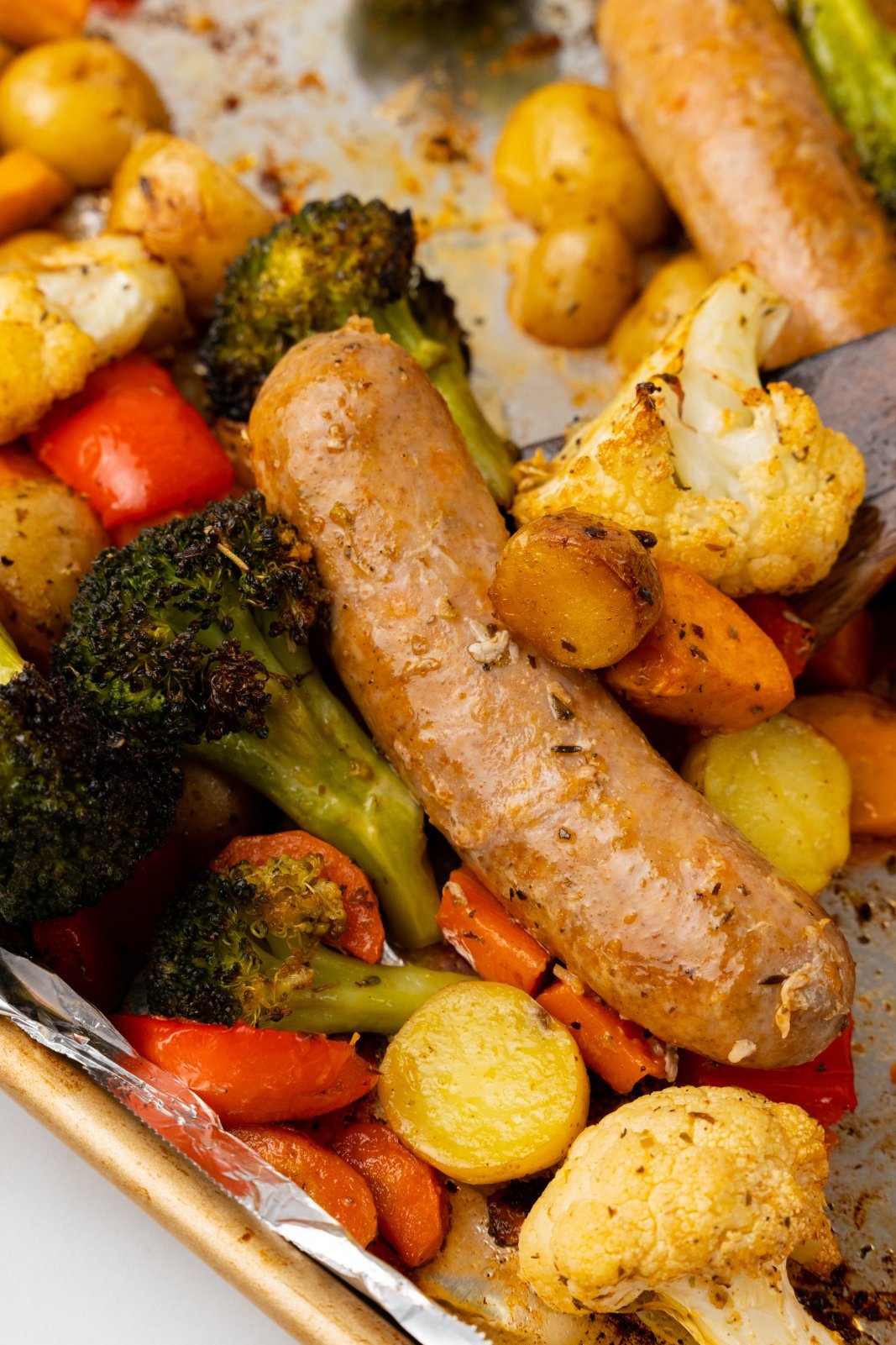 a close up of a sausage with veggies