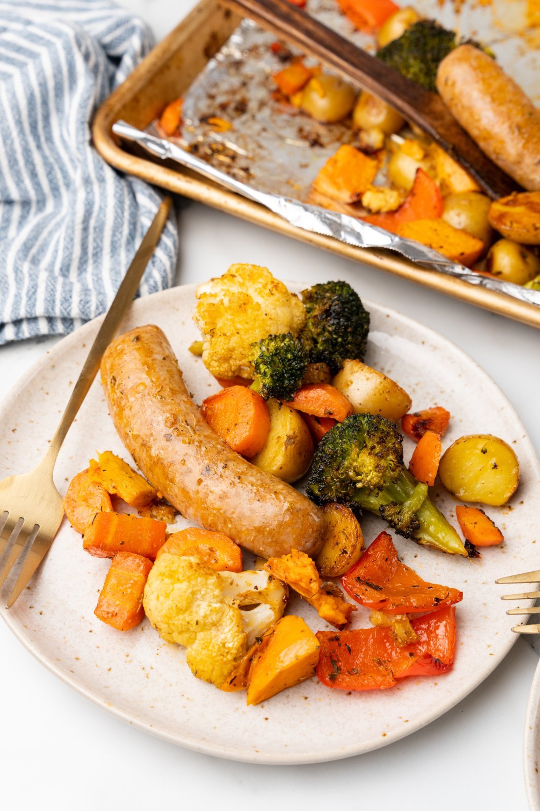 a plate with sausage and mixed veggies