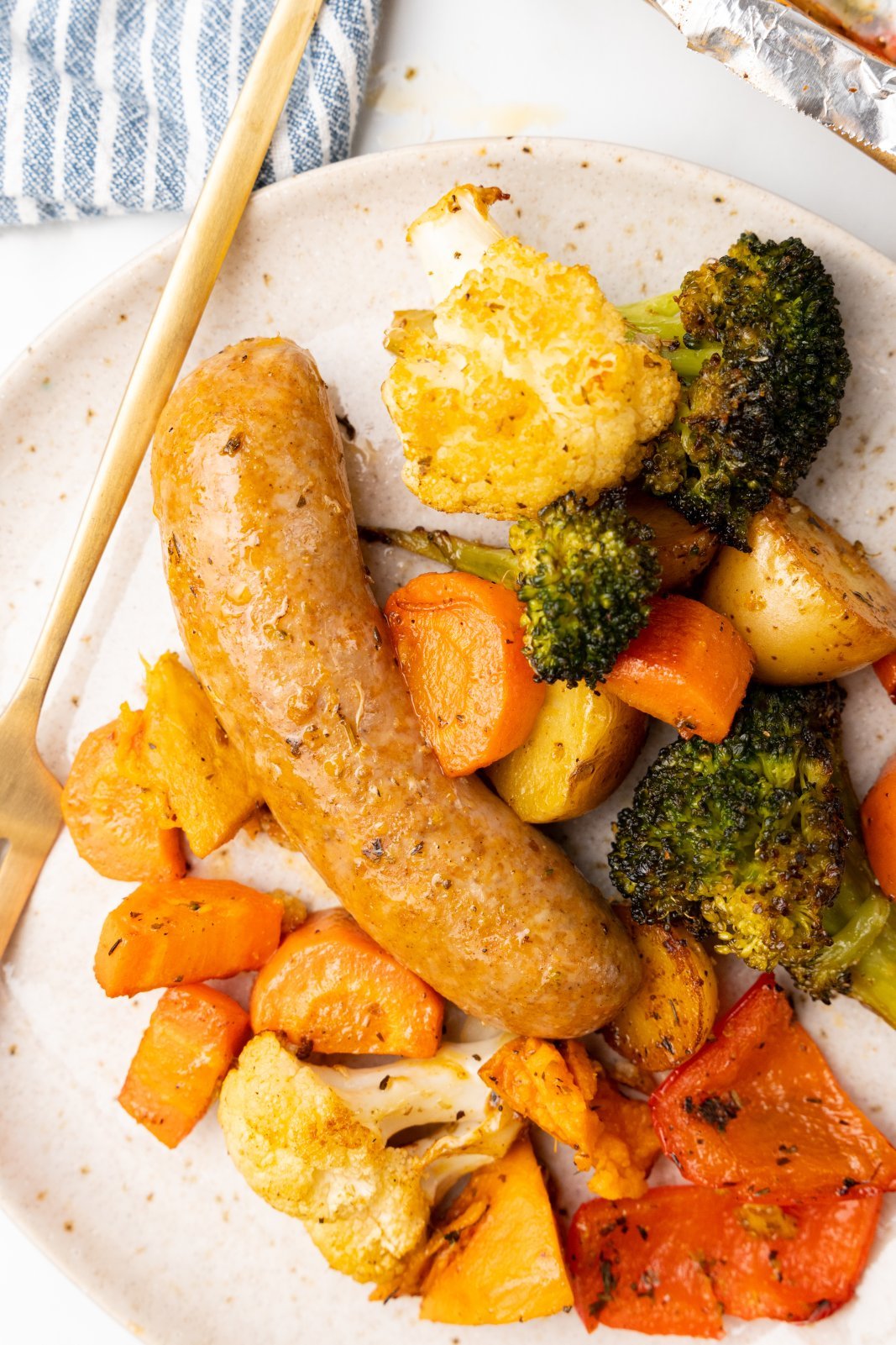 a close up of sausage and mixed veggies