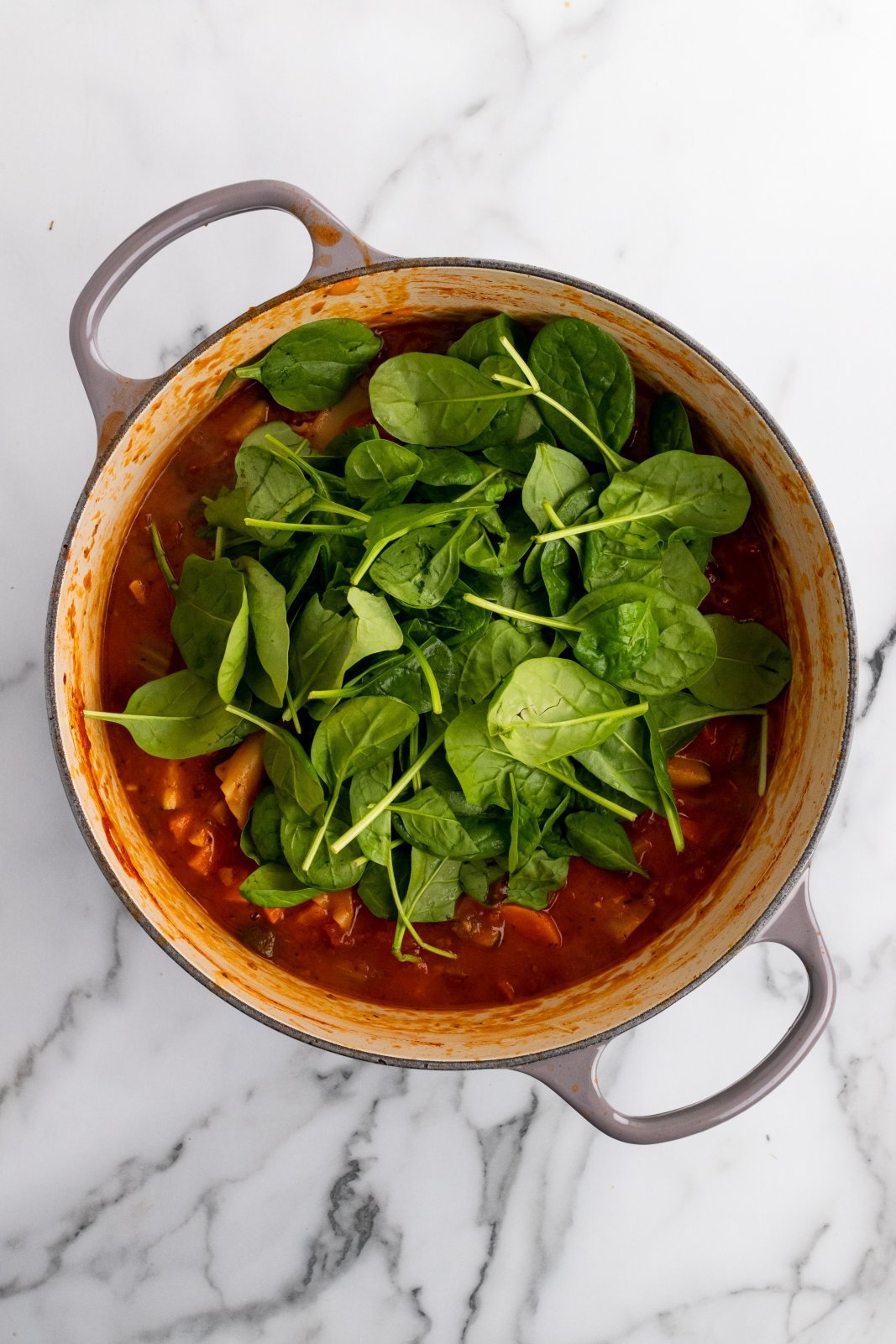 spinach added to the pot of soup