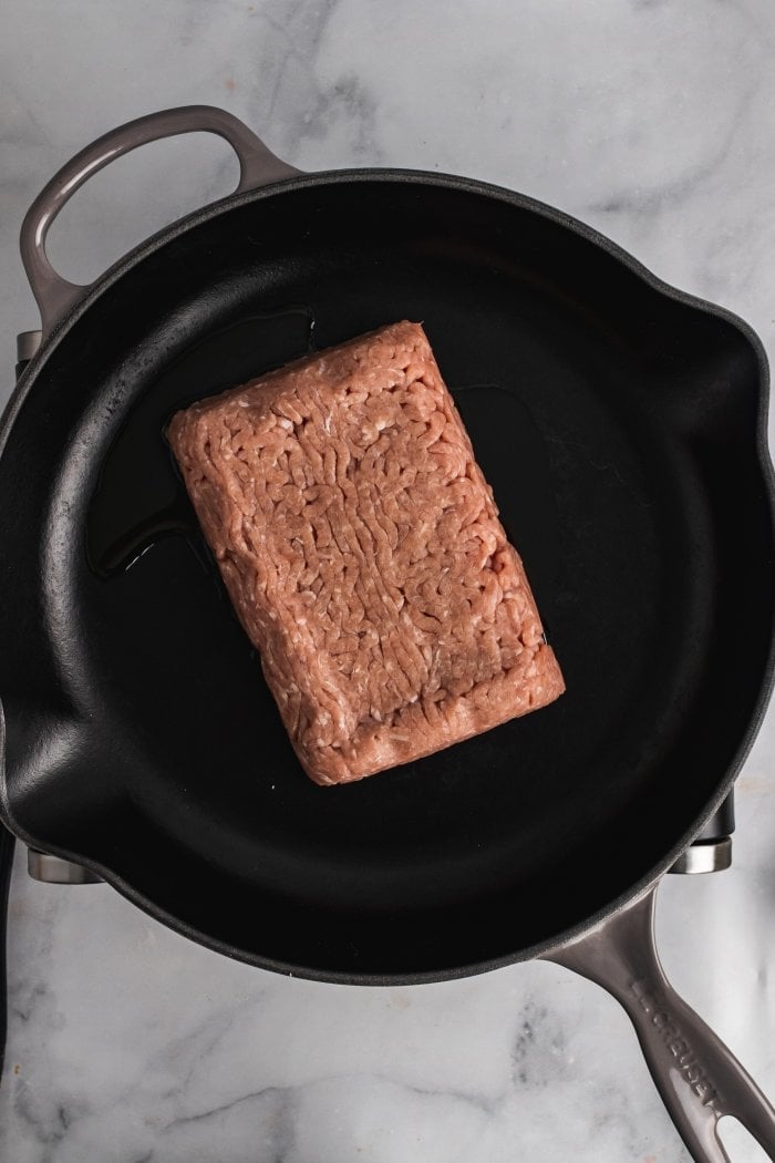 raw ground turkey is shown in a large skillet