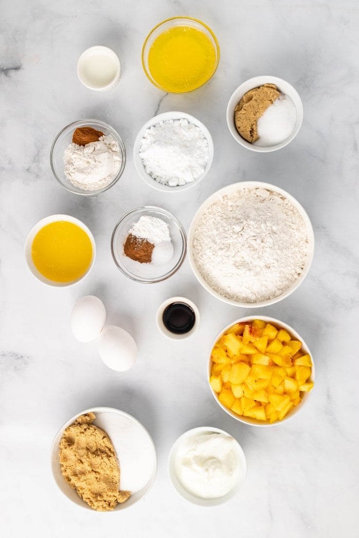 a top down view of the ingredients needed to make peach cobbler muffins