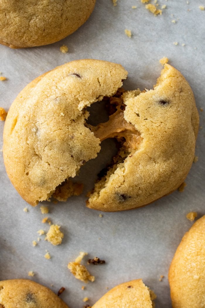 a cookie is split in half and pulled apart to show melted peanut butter