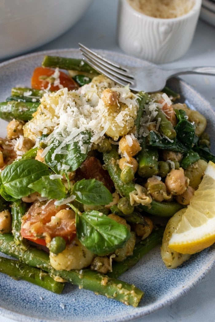 a close up of a plate of vegetarian pesto gnocchi